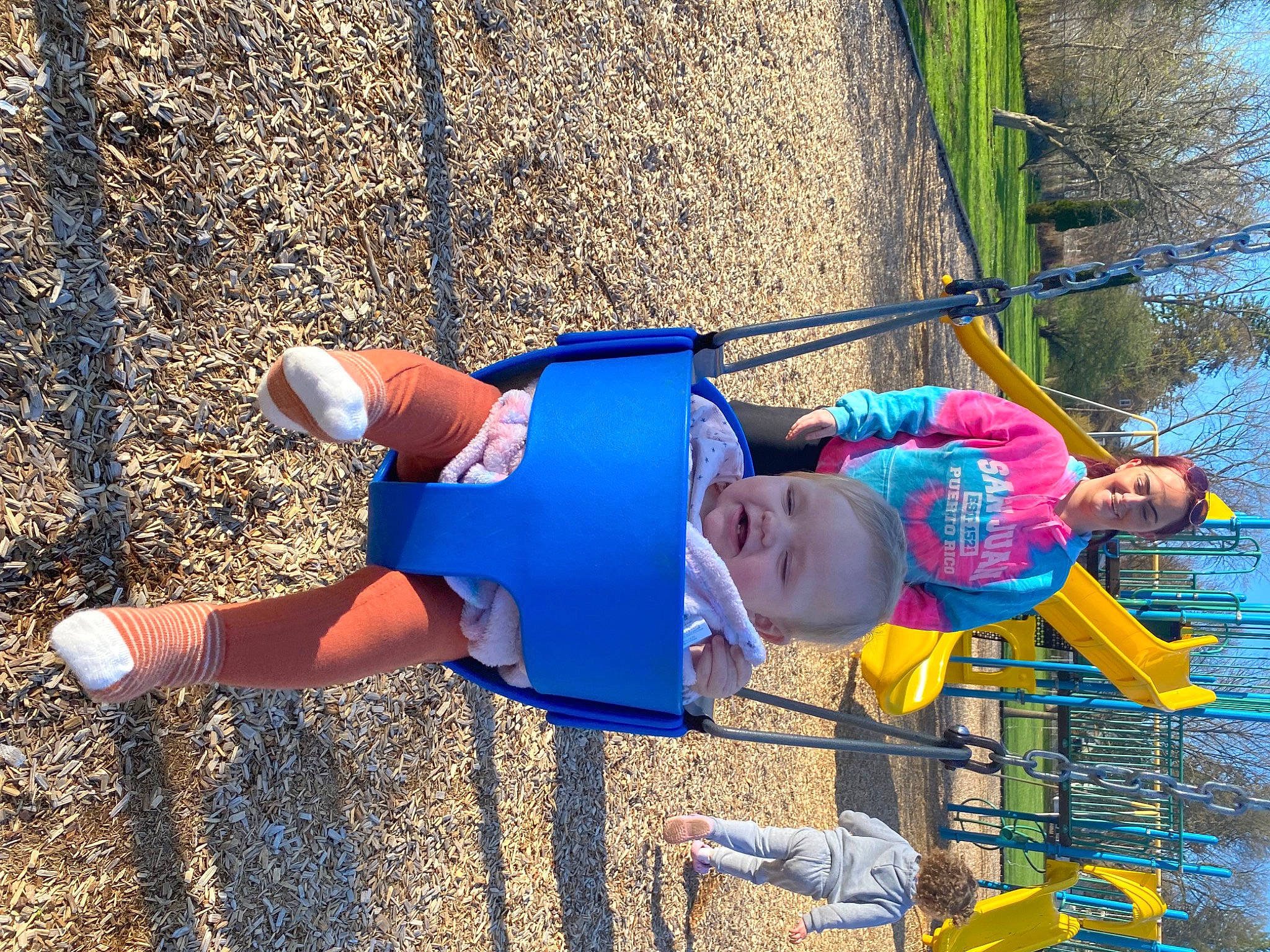 Scarlett is registered to the contest to win money with this photo: asphalt, boats_and_boating_equipment_and_supplies, child, electric_blue, fun, grass, hat, human_leg, joy, leisure, outdoor_play_equipment, people_in_nature, person, play, recreation, shadow, shorts, soil, toddler, tree