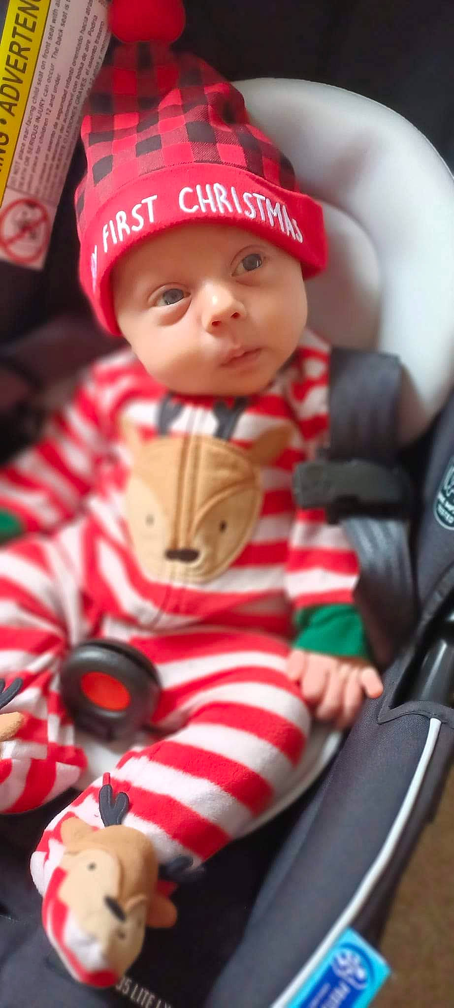 Kyson is registered to the contest to win money with this photo: baby, baby_toddler_clothing, cap, carmine, child, christmas, costume_hat, eye, fictional_character, fun, hat, headgear, headwear, holiday, human_body, lap, person, red, sitting, sleeve