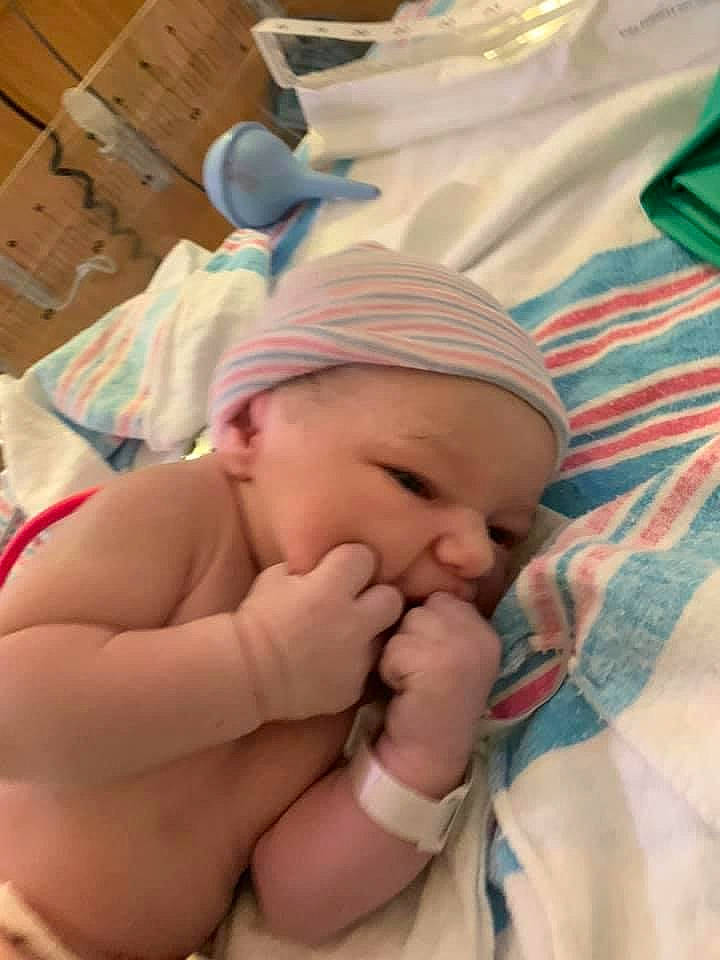 Emilie is registered to the contest to win money with this photo: baby, baby_products, baby_toddler_clothing, bedtime, cheek, child, childbirth, comfort, eye, fun, gesture, hand, happy, hat, headwear, linens, nail, person, room, sleep