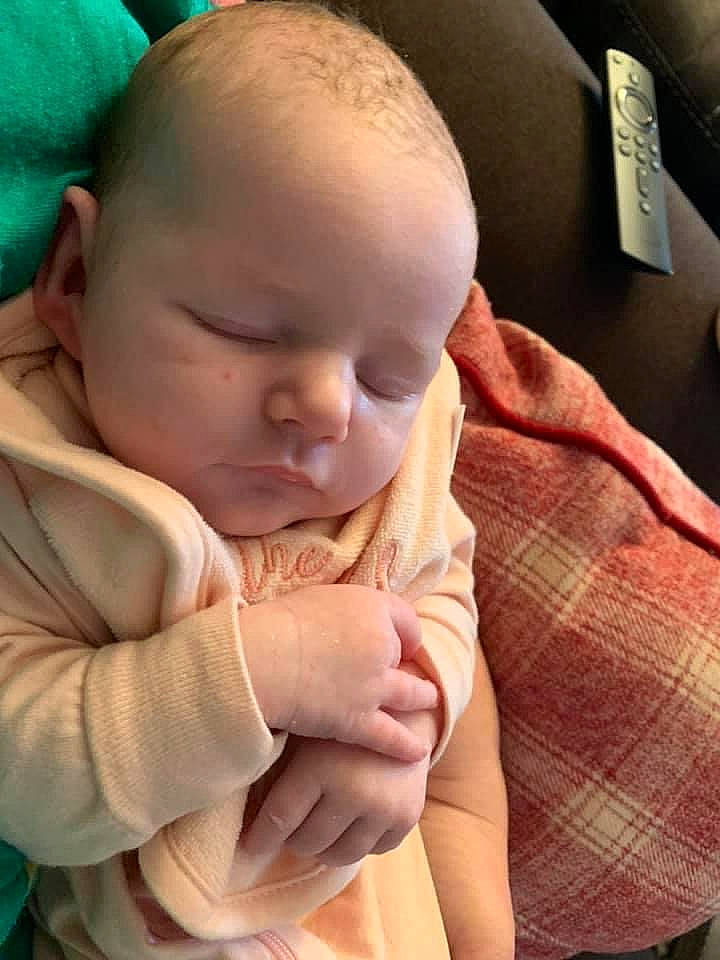 Emilie is registered to the contest to win money with this photo: baby, baby_toddler_clothing, cheek, chin, comfort, ear, eye, finger, gesture, hand, human_body, mouth, nail, neck, nose, person, skin, sleeve, thumb, toddler