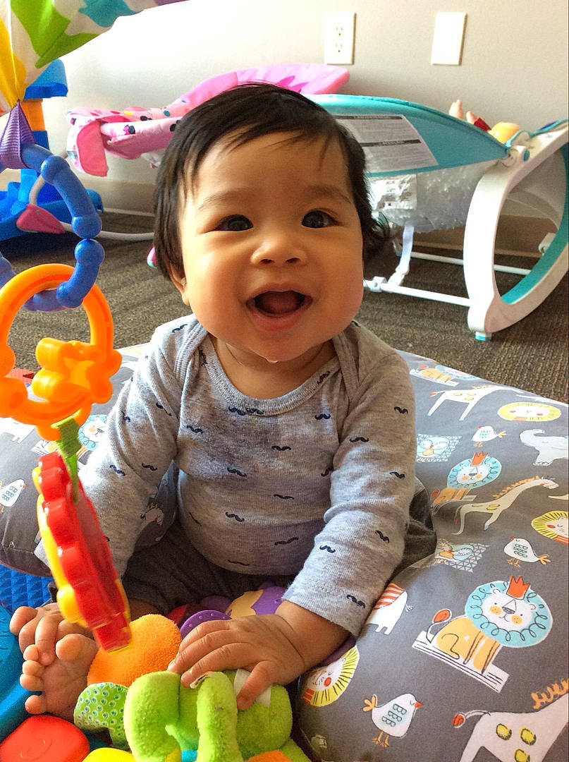Dexter is registered to the contest to win money with this photo: baby, baby_playing_with_toys, baby_products, baby_toddler_clothing, baby_toys, balloon, bed, cheek, child, dog_toy, human, linens, mouth, nose, party_supply, person, play, plush, toddler, toy