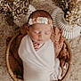 newborn, baby, sleeping, blanket, headband, flower, basket, dried_flowers, soft_texture, rug, cozy, wrapped, peaceful, portrait, indoor, infant, cute, decor, closeup, resting