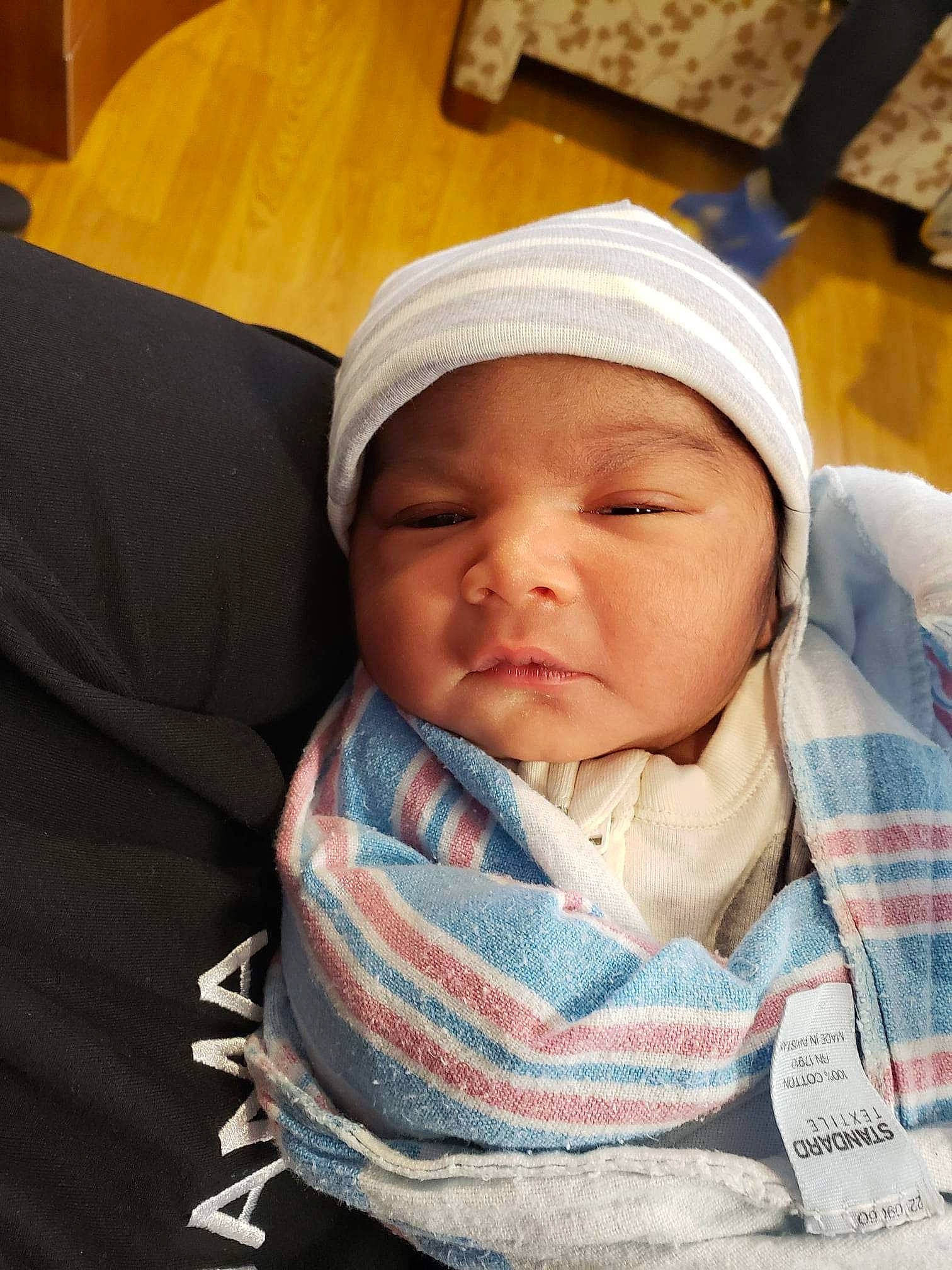 Armani joined the competition — help win amazing prizes! baby, baby_products, baby_sleeping, baby_toddler_clothing, beanie, cap, cheek, child, chin, comfort, eyebrow, headwear, knit_cap, linens, mouth, nose, person, plaid, room, sitting