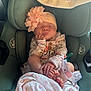 baby, newborn, car_seat, sleeping, flower_headband, pink, blanket, infant, cute, child, clothing, hand, foot, peaceful, soft, portrait, indoor, resting, cozy, person