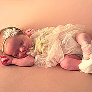 Wren is registered to the contest to win money with this photo: newborn, baby, sleeping, infant, headband, lace, dress, peach, soft, closeup, portrait, cute, peaceful, resting, small, delicate, footwear, indoors, skin, adorable