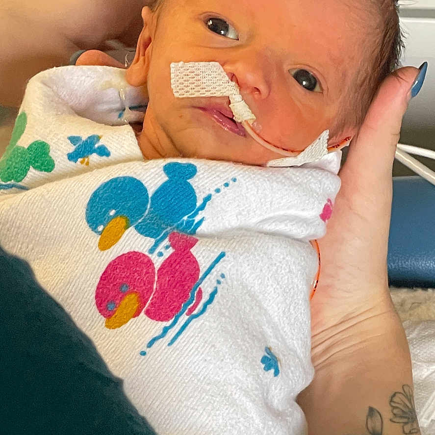 Hollyn joined the competition — help win amazing prizes! architecture, baby, bed, blanket, bodypart, building, clothing, cushion, face, finger, furniture, glove, hand, head, homedecor, hospital, newborn, person, photography, portrait