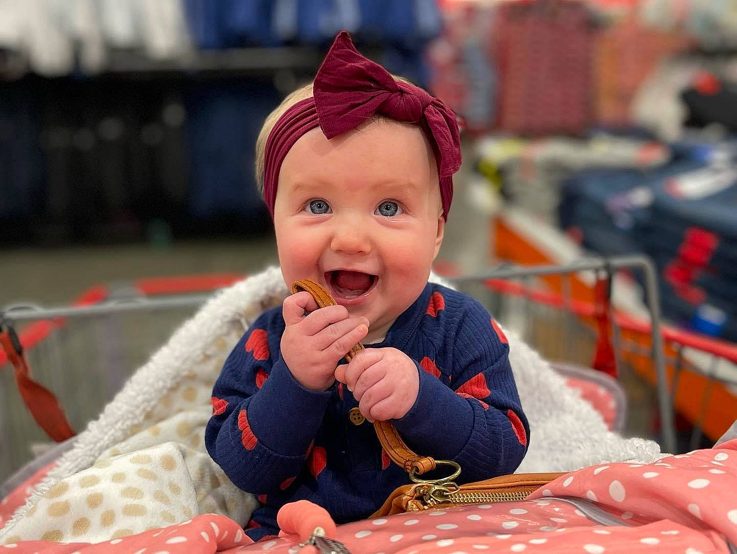 Hadlee is registered to the contest to win money with this photo: baby, cap, child, event, eye, fashion_accessory, fun, happy, headgear, headwear, human_body, leisure, orange, pattern, person, recreation, sitting, smile, toddler, tree