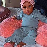 Josee is registered to the contest to win money with this photo: baby, infant, child, pink_bow, headwrap, grey_outfit, cushion, bed, blanket, soft_texture, toes, face, eyes, indoor, comfort, cute, toddler, seated, portrait, cozy