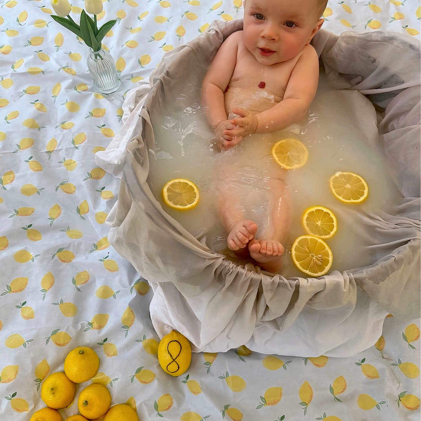 Eden participe au concours pour gagner de l'argent avec cette photo : baby, bathtub, blanket, child, cute, decor, expression, flower_vase, foot, hands, indoors, infant, lemon_slices, lemons, milk_bath, relaxed, skin, soft_light, water, white_tulips