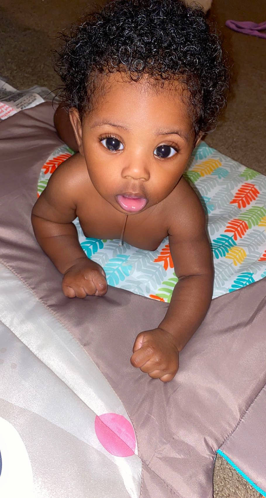 Jabari is registered to the contest to win money with this photo: baby, baby_toddler_clothing, cheek, comfort, eye, eyelash, face, facial_expression, finger, gesture, hand, happy, head, iris, lip, mouth, nose, person, pink, skin