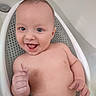 baby, infant, child, smiling, laughing, bathtub, bath_seat, bathroom, wet, bare_chested, portrait, face, eyes, open_mouth, happy, sitting, indoor, water, clean, playful