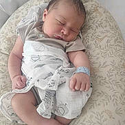 Ezra a rejoint le concours — aidez-le/la à gagner de superbes lots ! newborn, baby, sleeping, blanket, cushion, hospital_id_band, infant, soft_fabric, animal_print, leaf_pattern, peaceful, resting, wrapped, indoors, closeup, cute, small_hands, small_feet, head, portrait