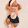 Calissia is registered to the contest to win money with this photo: baby, infant, girl, headband, pink, clothing, socks, denim, milestone, plaque, carpet, texture, cute, happy, portrait, child, lying_down, thumb_sucking, three_months, indoor