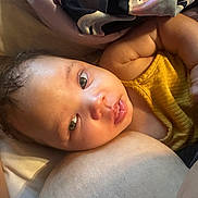 Calissia joined the competition — help win amazing prizes! baby, infant, face, eyes, skin, yellow_clothing, closeup, portrait, child, cute, newborn, soft_light, expression, curious, indoors, resting, person, human, warm_tone, blanket