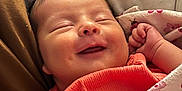 Brileyann joined the competition — help win amazing prizes! baby, infant, smiling, sleeping, blanket, clothing, coral, face, hand, dimple, comfort, cute, portrait, closeup, newborn, resting, cozy, soft, indoors, peaceful
