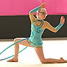 Lucie a rejoint le concours — aidez-le/la à gagner de superbes lots ! child, gymnast, gymnastics, hula_hoop, leotard, glasses, performance, sport, pose, floor, indoor, young, balance, flexibility, costume, athlete, dance, girl, expression, competition