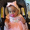 Wynter is registered to the contest to win money with this photo: baby, girl, pacifier, car_seat, pink_bow, pink_dress, minnie_mouse, headband, infant, child, cute, portrait, indoor, warning_label, stripes, seat, apparel, looking_at_camera, sitting, hand