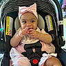 Wynter is registered to the contest to win money with this photo: baby, infant, car_seat, pink, headband, bow, pacifier, smiling, child, indoor, seatbelt, clothing, tulle, happy, person, sitting, cute, toddler, safety, accessory