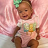Paisley joined the competition — help win amazing prizes! baby, child, smiling, headband, green_bow, pink_outfit, popsicle_design, sitting, white_socks, pink_satin_backdrop, cute, happy, portrait, indoor, infant, person, apparel, fashion, baby_clothes, soft_texture