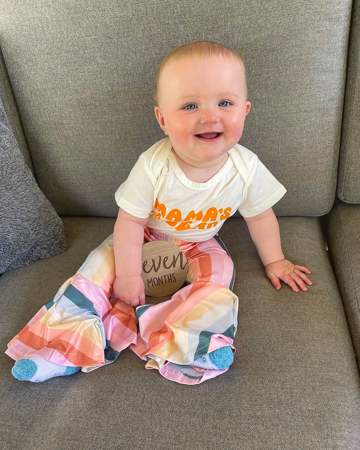 Sadie is registered to the contest to win money with this photo: baby, baby_toddler_clothing, cheek, child, comfort, eye, floor, flooring, fun, happy, joy, pattern, person, product, shorts, sitting, skin, sleeve, smile, sock