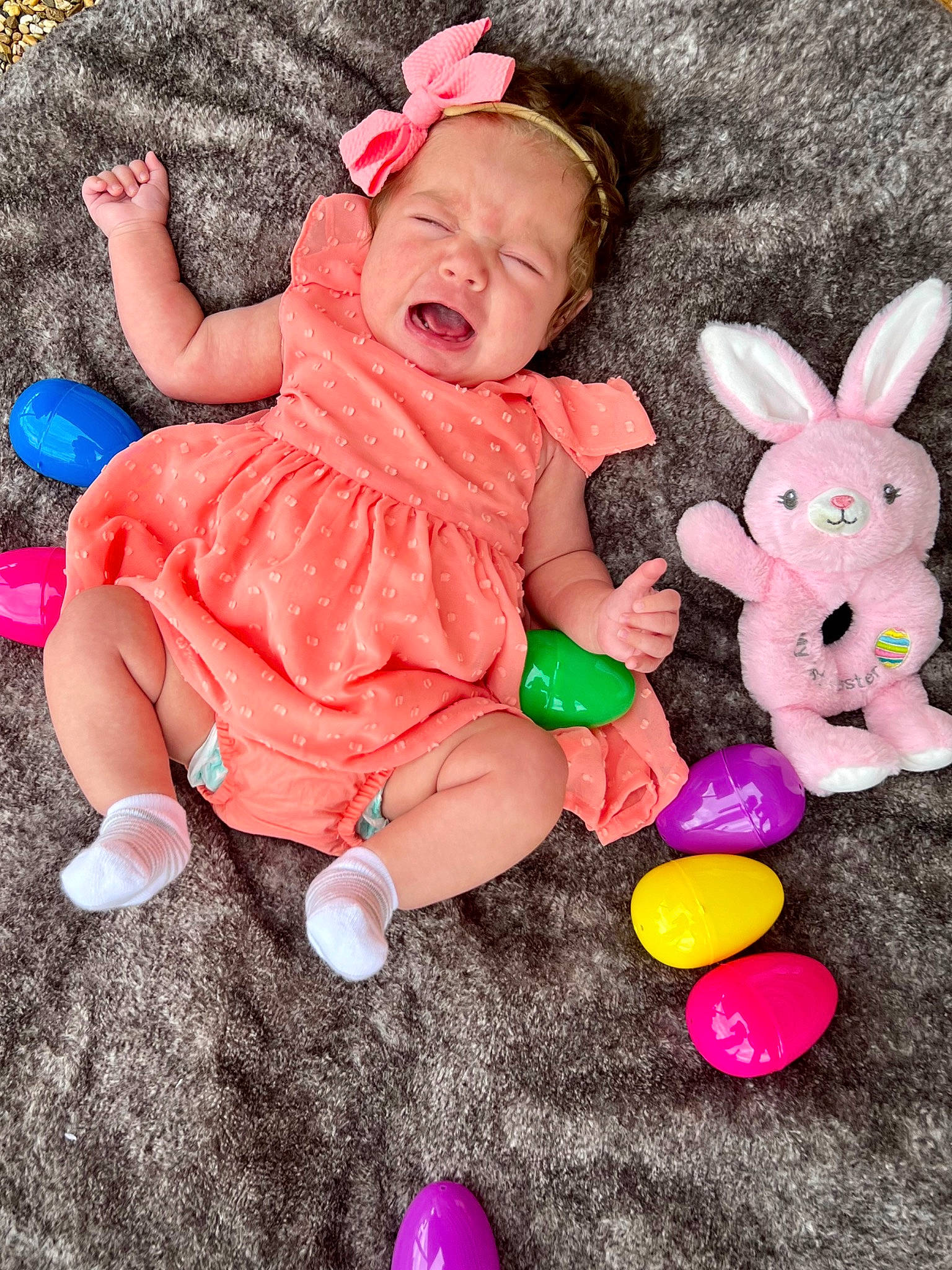 Hazel is registered to the contest to win money with this photo: baby, baby_toddler_clothing, baby_toys, child, event, finger, fun, grass, happy, magenta, person, photograph, pink, play, sitting, skin, sock, textile, toddler, toy