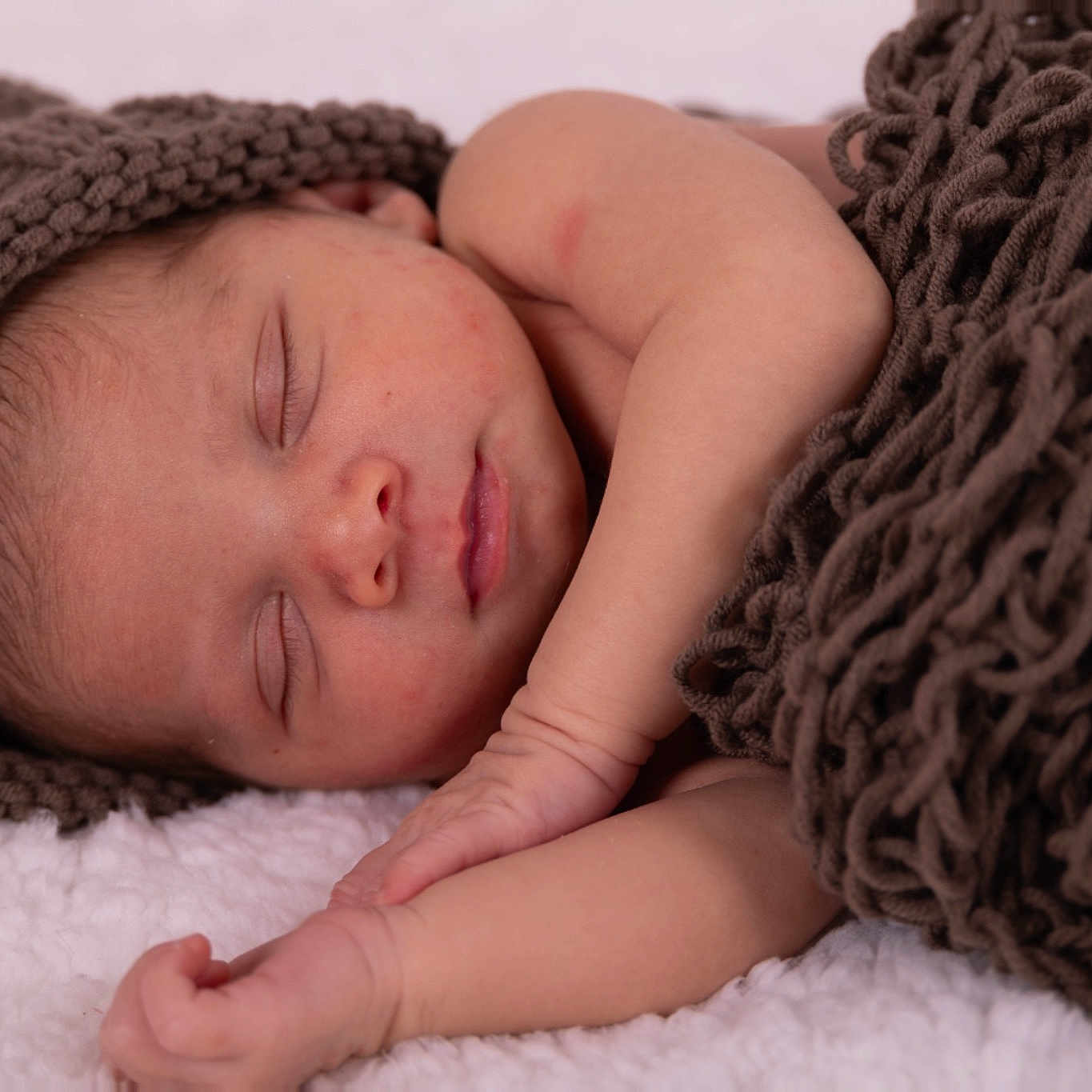 Kashton is registered to the contest to win money with this photo: baby, bedding, bedtime, close_up, comfort, eye, eyebrow, eyelash, grey, hair, headgear, knit_cap, linens, mammal, nose, pattern, product, skin, vertebrate, wool