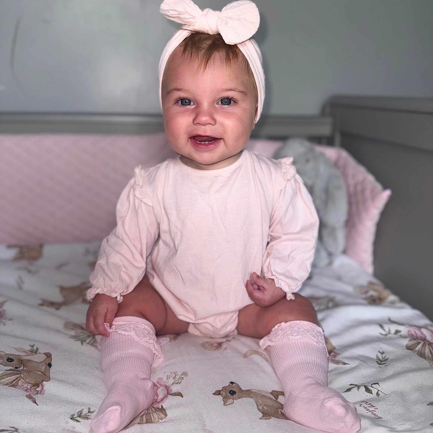 Ivy-Jean joined the competition — help win amazing prizes! baby, blanket, bow, child, crib, cute, deer_pattern, floral_pattern, happy, headband, indoor, infant, knee_socks, nursery, person, pink_clothing, portrait, sitting, smiling, soft_lighting