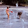 animal, barefoot, child, dog, fun, leash, nature, outdoor, park, playful, recreation, splash_park, summer, sunny_day, swimsuit, trees, water_fountains, water_spray, wet_dog, young_girl