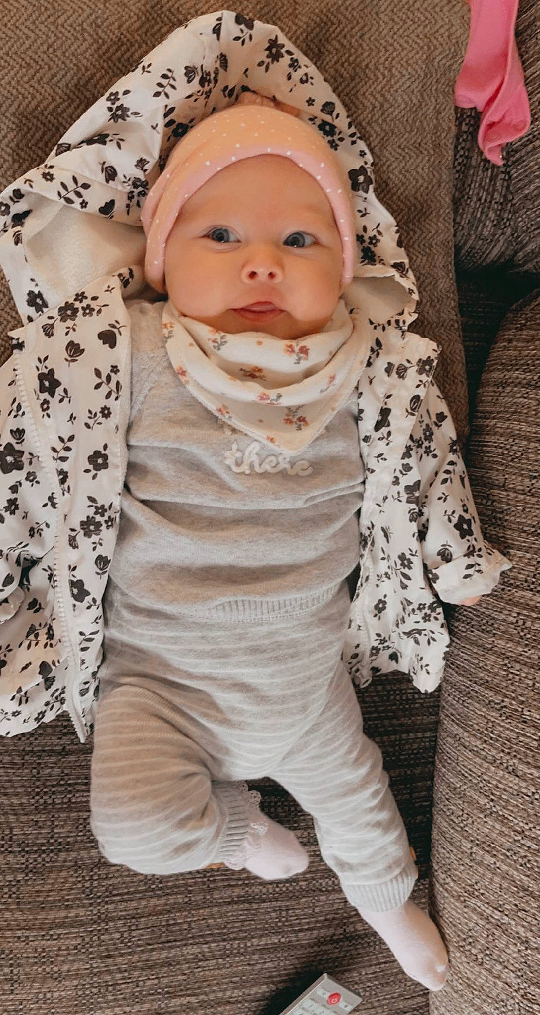 Ella-rose is registered to the contest to win money with this photo: baby, baby_toddler_clothing, cap, comfort, eye, face, finger, happy, hat, head, headgear, headwear, human_body, leg, lip, neck, outerwear, person, plant, skin