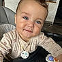 Elyas participe au concours pour gagner de l'argent avec cette photo : baby, blue_eyes, child, closeup, clothing, curious, cute, face, furniture, hair, high_chair, home, indoor, infant, pacifier_clip, person, skin, smile, toy, young