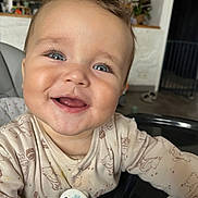 Elyas participe au concours pour gagner de l'argent avec cette photo : baby, blue_eyes, child, closeup, clothing, cute, face, furniture, happy, head, high_chair, home, indoor, infant, long_eyelashes, person, portrait, skin, smiling, toy