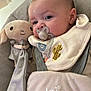 baby, pacifier, bib, soft_toy, plush, baby_seat, infant, child, cute, portrait, indoor, comfort, clothing, face, young_child, baby_accessory, toy, childcare, closeup, relaxing