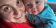 Spencer joined the competition — help win amazing prizes! baby, baby_clothes, blue_clothing, car_interior, child, childhood, close_up, cute, eyes, face, hand, happy, holding, human, parent, portrait, red_sweater, skin, smile, woman