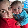baby, baby_clothes, blue_clothing, car_interior, child, childhood, close_up, cute, eyes, face, hand, happy, holding, human, parent, portrait, red_sweater, skin, smile, woman