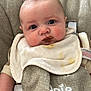 baby, infant, bib, stain, feeding, seat, child, cute, face, mouth, clothing, indoor, expression, young, skin, head, person, eyes, hand, sitting