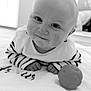 Arthur participe au concours pour gagner de l'argent avec cette photo : baby, infant, smile, face, striped_clothing, toy, ball, towel, lying_down, indoors, cute, child, portrait, black_and_white, soft_texture, hands, eyes, head, small, young