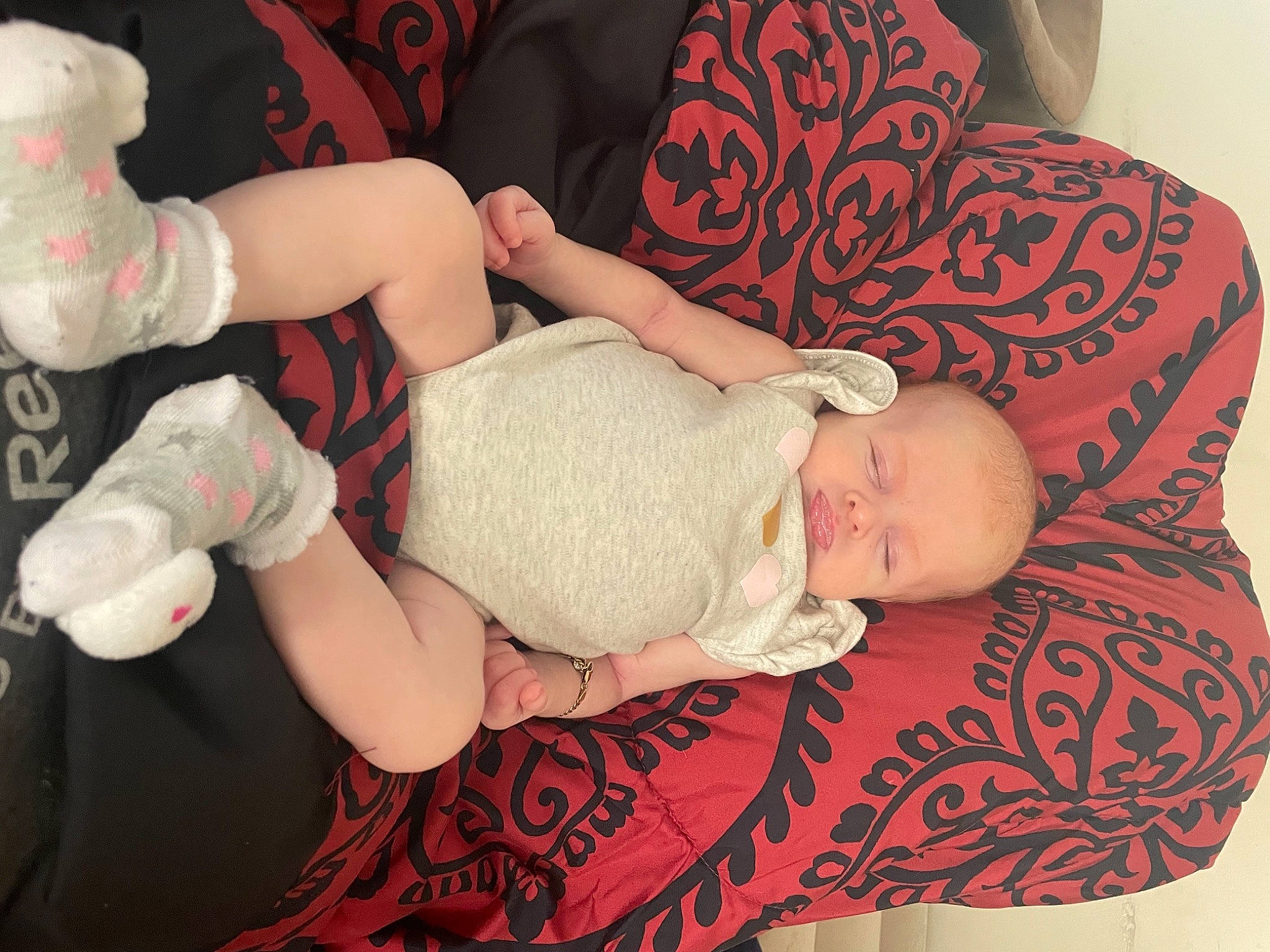 Ella-mae is registered to the contest to win money with this photo: arm, baby, baby_toddler_clothing, cheek, comfort, facial_expression, finger, gesture, glasses, hand, human_body, joint, lap, leg, person, pink, product, skin, textile, thigh
