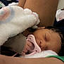 Daja is registered to the contest to win money with this photo: newborn, baby, sleeping, pacifier, blanket, hand, face, infant, cozy, soft, wrapped, rest, child, cute, indoors, skin, person, comfort, closeup, peaceful