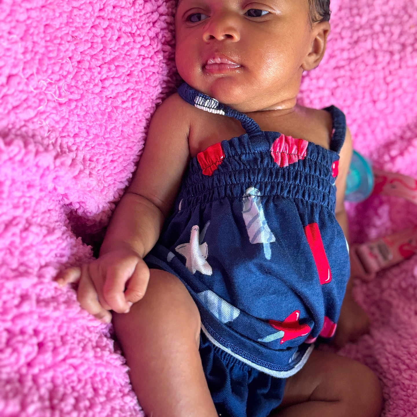 Daja joined the competition — help win amazing prizes! baby, blue_outfit, child, cozy, curious_expression, cute, face, hand, indoors, infant, legs, lying_down, newborn, pink_blanket, portrait, red_accents, skin, sleepwear, soft_texture, toddler