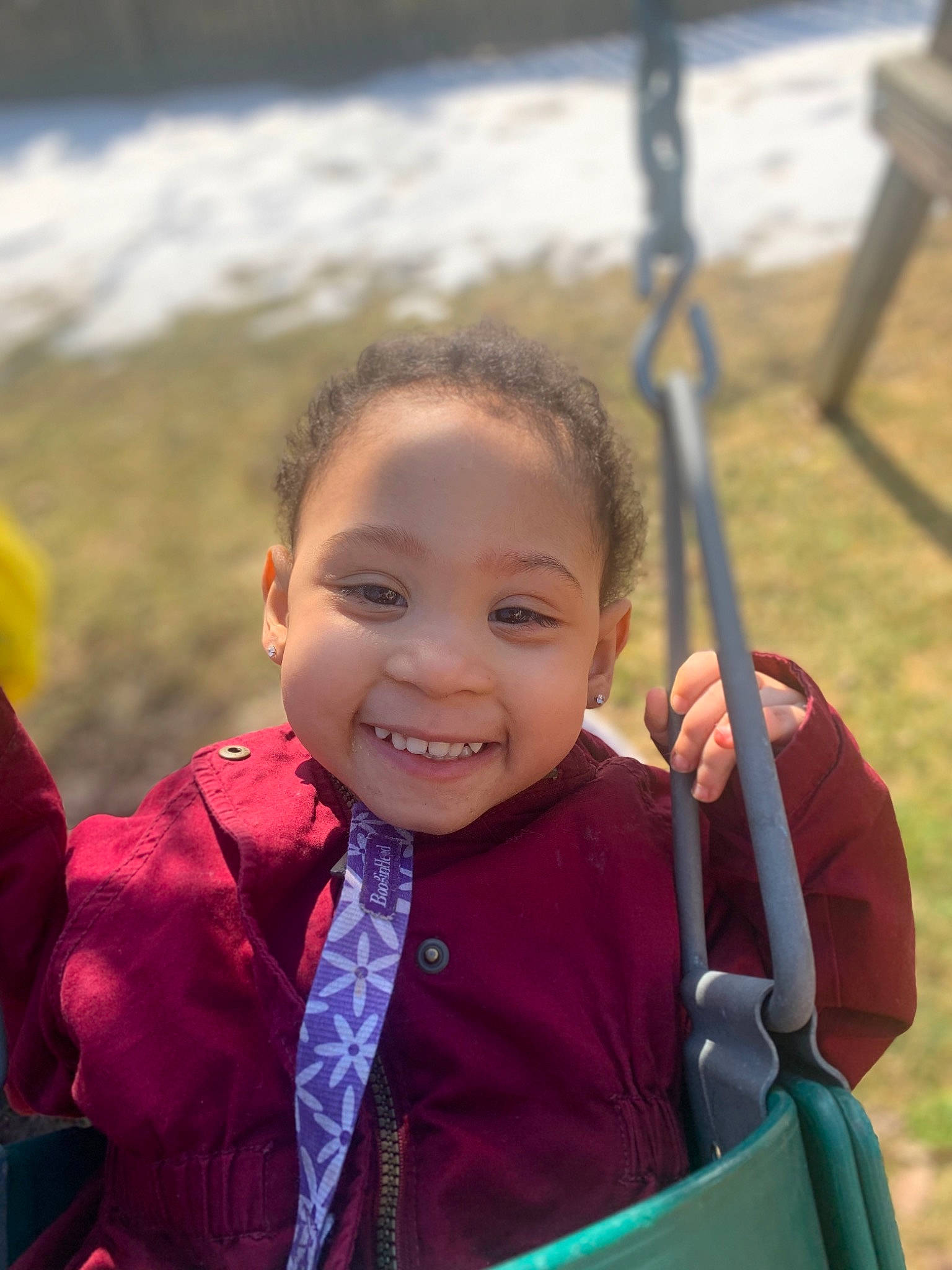 Amiya is registered to the contest to win money with this photo: baby, child, city, eye, fun, grass, happy, joy, leisure, outdoor_play_equipment, people_in_nature, person, play, playground, recreation, sitting, skin, smile, swing, toddler