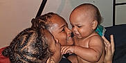 Diamond is registered to the contest to win money with this photo: baby, child, adult, smiling, braided_hair, backpack, indoor, bed, family, affection, happy, holding, person, wall, diaper, clothing, closeup, portrait, interaction, love