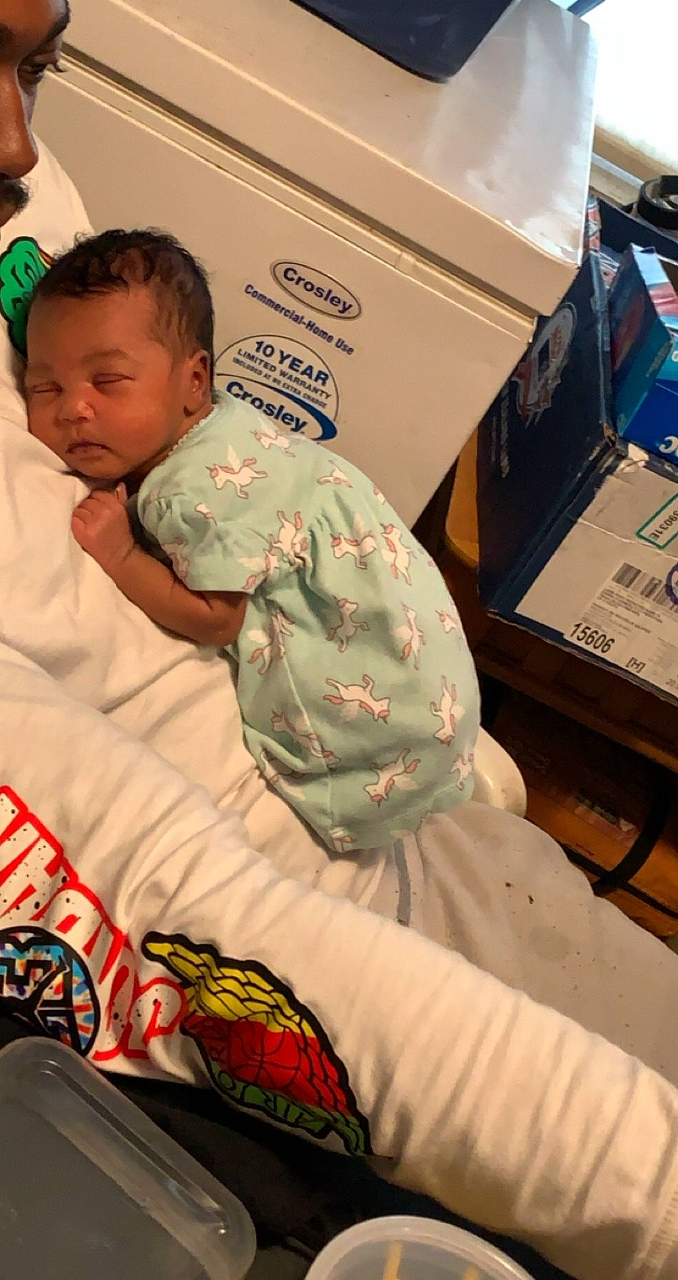 Gabriella is registered to the contest to win money with this photo: baby, baby_products, baby_toddler_clothing, bed, box, cardboard, comfort, office_equipment, person, shipping_box, toddler