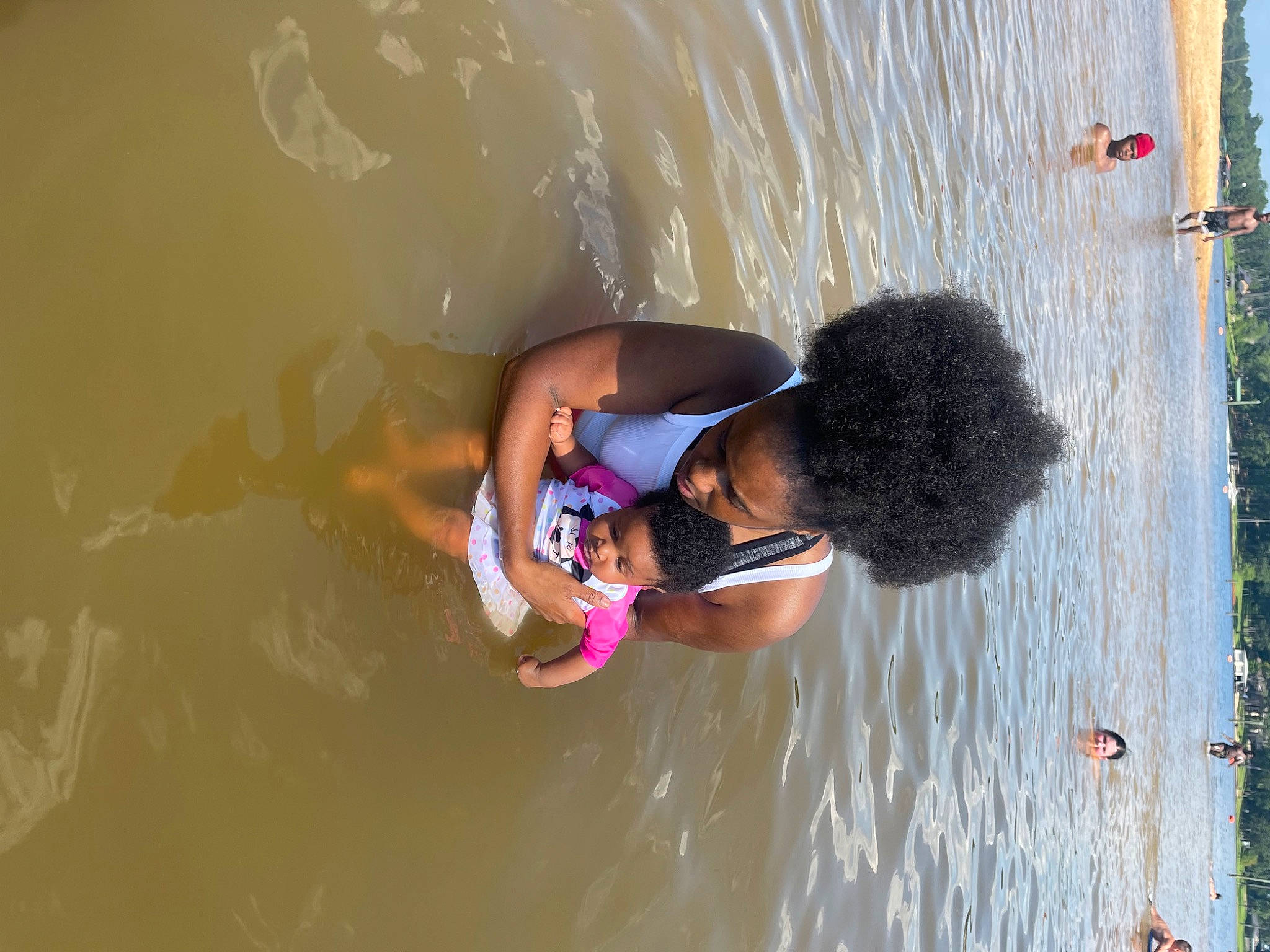 Eternity is registered to the contest to win money with this photo: arm, beach, blurred, fun, happy, headwear, joy, lake, leisure, people_in_nature, person, plant, recreation, reflection, sand, shorts, sky, sunglasses, swimwear, toddler