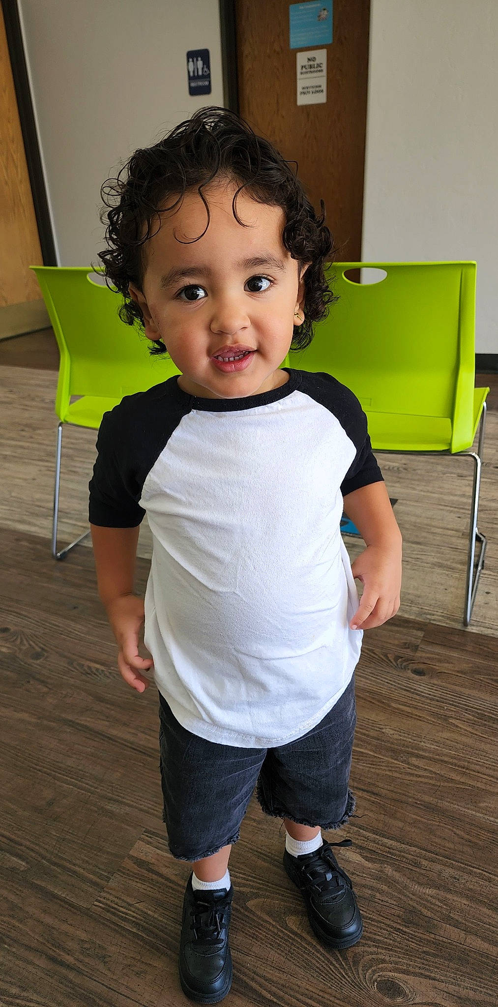 Luciano is registered to the contest to win money with this photo: baby_toddler_clothing, cheek, child, elbow, face, flooring, fun, happy, hardwood, joint, leg, person, room, shorts, shoulder, sitting, sleeve, standing, t_shirt, toddler
