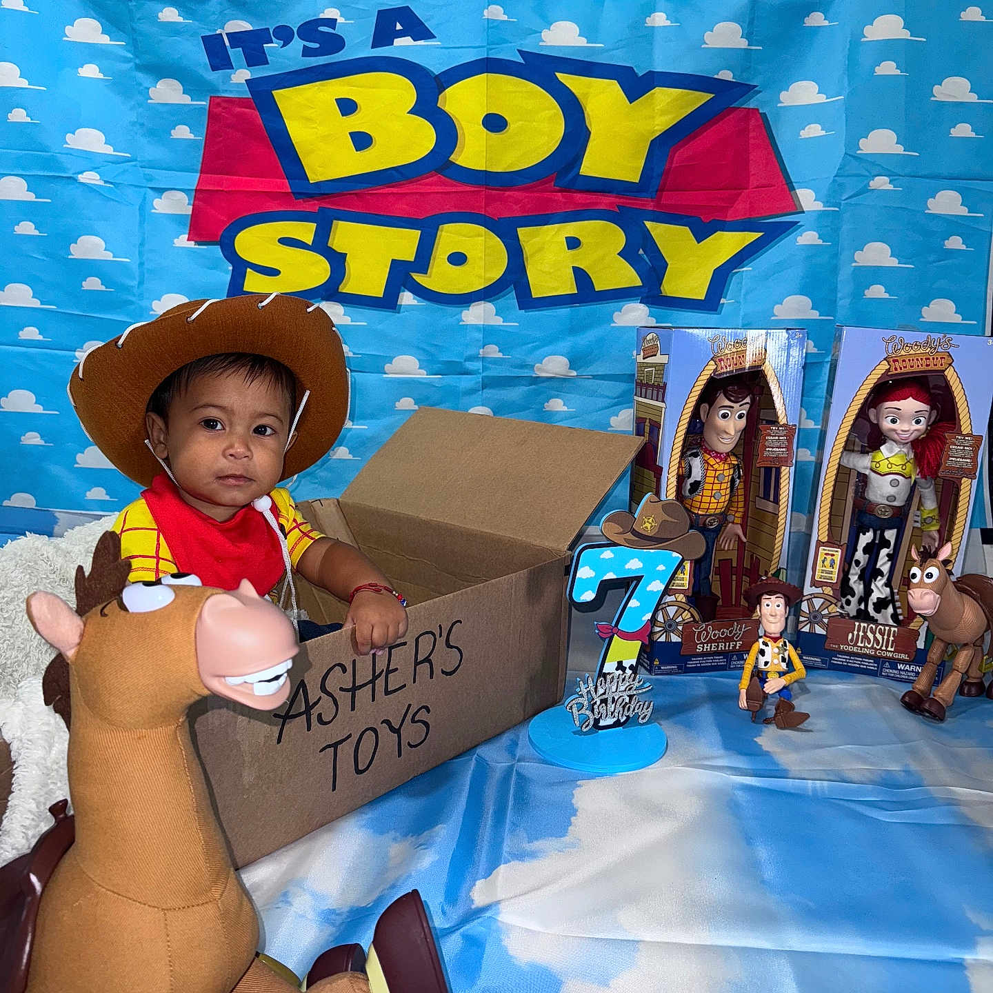 Asher Javier joined the competition — help win amazing prizes! birthday, birthday_candle, birthday_party, blue_backdrop, bullseye, cardboard_box, celebration, child, cloud_pattern, cowboy_hat, indoor, jessie, person, red_bandana, smiling_child, toddler, toy, toy_story, toys, woody