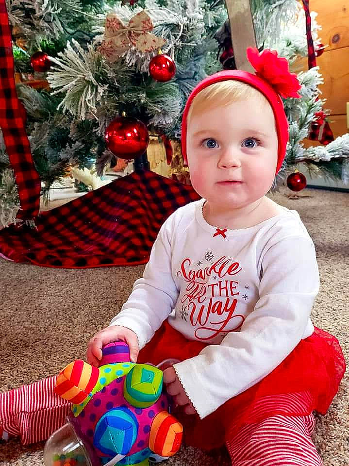 Ivory is registered to the contest to win money with this photo: baby, baby_toddler_clothing, child, christmas_ornament, christmas_tree, event, fun, happy, headwear, holiday, organ, pattern, people, person, photograph, sleeve, smile, snapshot, standing, toddler