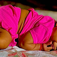 Vyraih joined the competition — help win amazing prizes! baby, child, infant, pink_clothing, blanket, lying_down, curly_hair, skin, cute, toddler, sleepwear, indoors, soft_texture, resting, small, portrait, one_person, relaxed, cozy, close_up