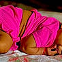 baby, child, infant, pink_clothing, blanket, lying_down, curly_hair, skin, cute, toddler, sleepwear, indoors, soft_texture, resting, small, portrait, one_person, relaxed, cozy, close_up
