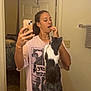 bathroom, black_and_white_cat, casual_clothing, cat, countertop, door, home, interaction, interior, mirror, pet, phone, playful, reflection, selfie, sink, standing_cat, towel, woman, young_adult