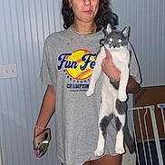 Earl joined the competition — help win amazing prizes! baby_gate, blue_wall, bracelet, casual, cat, curly_hair, earrings, expression, flash, floor, glowing_eyes, gray_tshirt, holding, home, indoor, light_switch, pet, phone, standing, woman